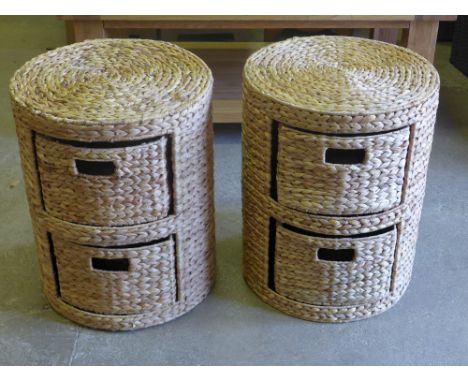 A pair of round wicker arrow weave two drawer storage units