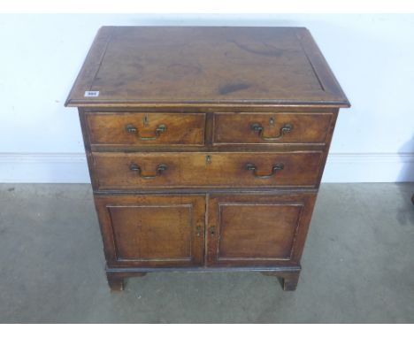 A George III mahogany converted commode chest - the rectangular top above and arrangement of two short and one long drawer an