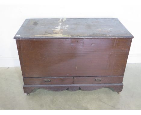 A hinged lidded trunk with two drawers over shaped apron raised on bracket suppors