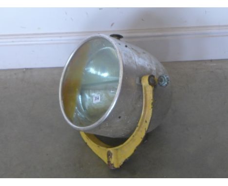 A large aluminium Aircraft landing light by Harley - mounted on a U shaped Gimble bracket - Diameter 30 cm - Total height app
