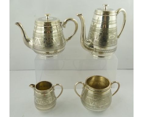 AN EDWARDIAN SILVER PLATED FOUR-PIECE TEA AND COFFEE SERVICE, having chased decoration, comprising a teapot, coffee pot, suga