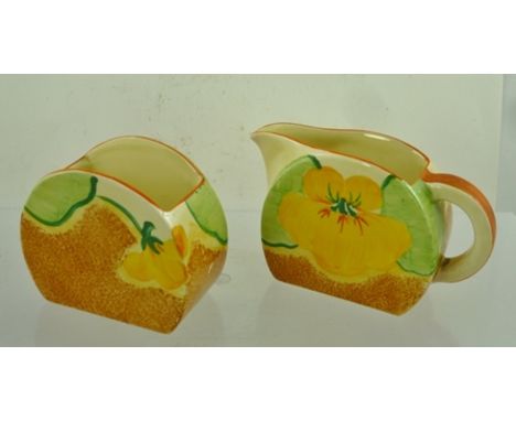 CLARICE CLIFF A "NASTURTIUM" PATTERNED PAINTED CREAM JUG AND SUGAR BOWL, circa 1930, having factory back stamp, sugar bowl 6c