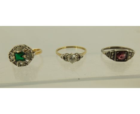 A SELECTION OF THREE STONE SET DRESS RINGS comprising; a Victorian red stone set silver dress ring, having illusion shoulders