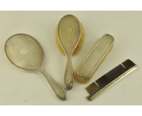 AN EARLY TO MID 20TH CENTURY SILVER HAND MIRROR, having engine turned decoration, London 1918, together with two BRUSHES and 