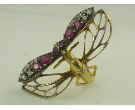 A RUBY AND DIAMOND SET GOLD COLOURED METAL DRESS RING fashioned as a butterfly with gem set wings, unmarked, ring size M 