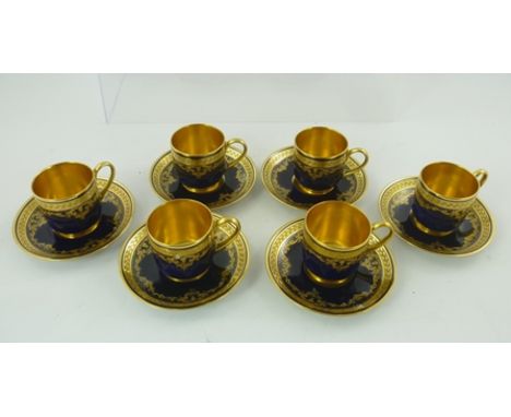 A SET OF SIX LIMOGES COFFEE CUPS with saucers, gilded cobalt blue design with gilt interiors, retailed by "Mappin & Webb" 