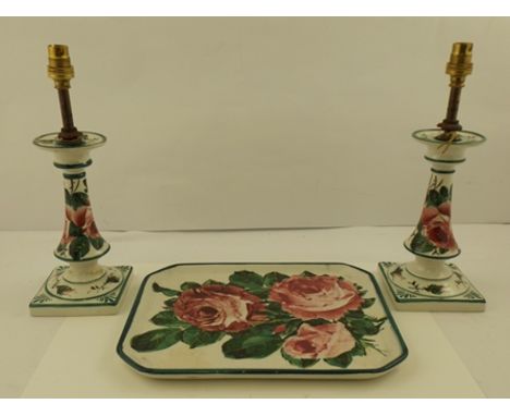 A TRIO OF WEMYSS EARTHENWARES comprising; a pair of candlesticks 18cm high (later fitted for electricity) and a rectangular t