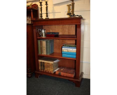 A mahogany bookcase with two adjustable shelves and reeded uprights, on bracket feet, 77cm