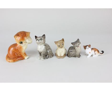 Two Royal Doulton porcelain models of kittens, a Beswick kitten (1886), a Goebel model of a ginger kitten, and a Szeiler mode