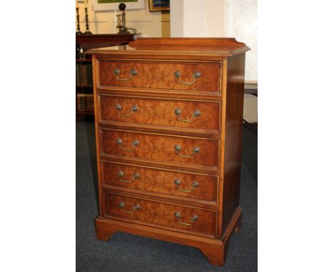 An inlaid yew wood chest of five drawers with brass drop handles, on bracket feet, 67cm