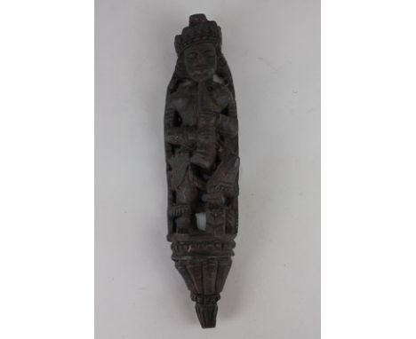 A carved wooden figure playing a pipe, 30cm long
