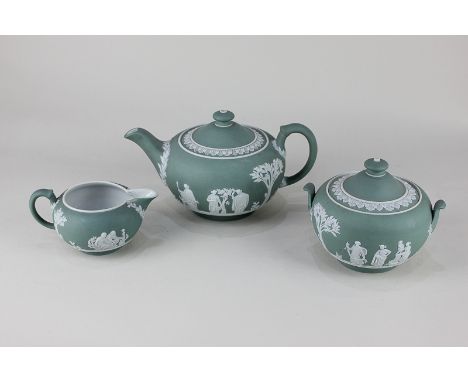 A Wedgwood green Jasperware tea set comprising teapot, sugar bowl and cover (a/f) and milk jug