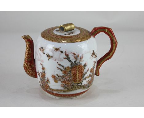 A Japanese Kutani porcelain teapot, decorated in rust and gilt with birds amongst a garden, and a landscape, character marks 