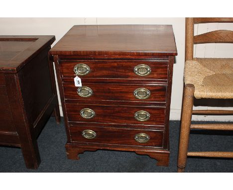 A small mahogany chest of four drawers with decorative brass embossed back plates and drop handles, on bracket feet, 52cm