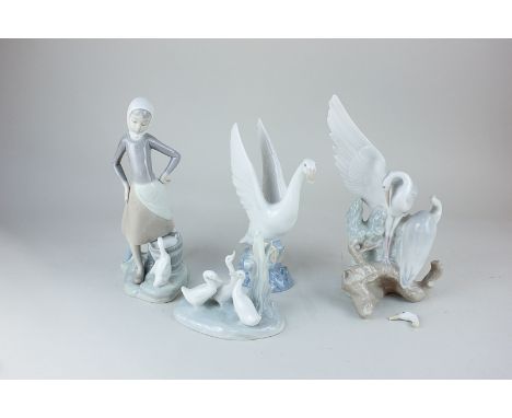 A Lladro figure of a girl beside a duck drinking from a pail, 24cm, together with three Nao models of birds, to include a whi