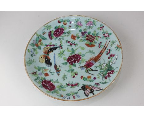 A Chinese celadon plate depicting birds, butterflies and flowers, seal mark to base, 24.5cm diameter