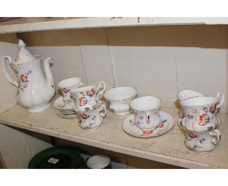 A Royal Albert porcelain tea set, decorated with red and purple flowers on white ground, comprising teapot milk jug, sugar bo