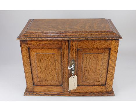 An oak pipe smoker's cabinet enclosing two drawers, 36.5cm