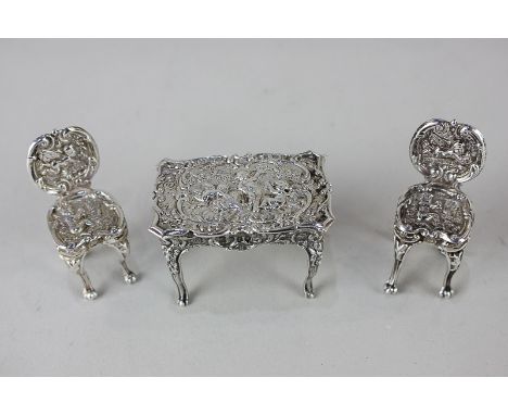 A Victorian imported silver miniature model of a table with two chairs, retailed B Muller &amp; Son, London 1895, with emboss