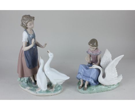 Two Nao figure groups of a girl with two swot geese, 28cm, and seated beside a swan, 20cm