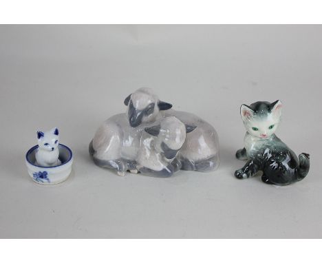A Royal Copenhagen porcelain model of two lambs, 7cm, together with a Goebel Hummel model of a kitten with a spider on her ta