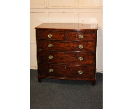 A 19th century mahogany bow-front chest of two short over three long drawers with oval brass handles, on bracket feet (a/f), 