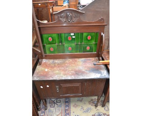 An Art Nouveau tile back washstand, rouge marble top, single door cupboard to base