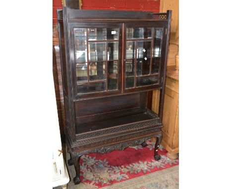 A mahogany Chippendale revival display cabinet on stand, two astragal bevel glass doors enclosing shelving over recess with f