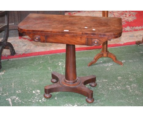 A mahogany card table, rounded fold over top enclosing green baize playing surface, spreading cylindrical column, quatrefoil 