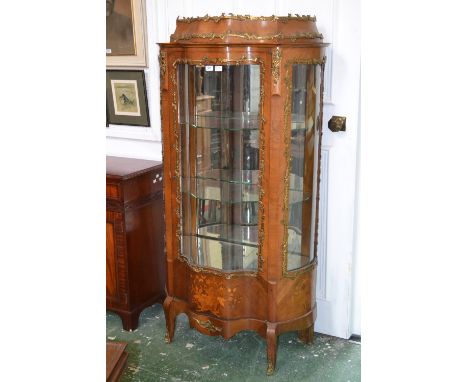 A Louis XV Revival gilt metal mounted kingwood and marquetry bombe shaped vitrine, caddy top above a glazed door, the base in