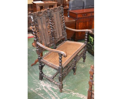 A Carolean revival two seat settee, pierced and carved top rail, compressed ovoid finials, barley twist uprights,  wickerwork