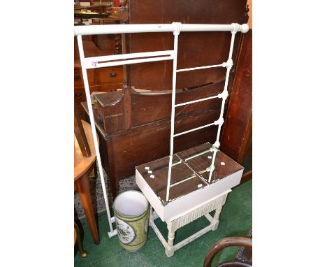 A white painted metal double bed head board; a white painted stool; a bathroom cabinet with mirrored doors; a ceramic umbrell