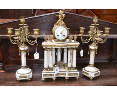 A French Second Empire ormolu and alabaster portico clock garniture, 7.5cm convex enamel dial inscribed with Arabic numerals 