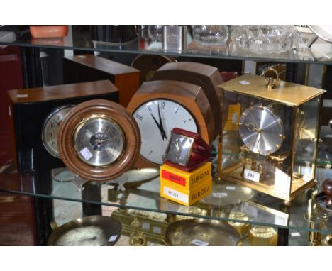 A Smiths teak mantel clock, Arabic numerals; a German Kundo brass clock; a treen mounted circular wall barometer; travel cloc