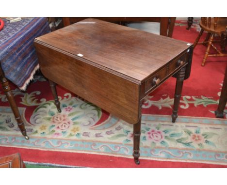 A George III mahogany Pembroke table,rounded rectangular top, drawers to both ends, button handles, turned legs, ceramic cast