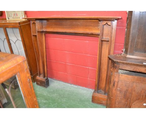 An oak Arts and Crafts style fire surround