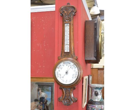 A Victorian oak aneroid barometer