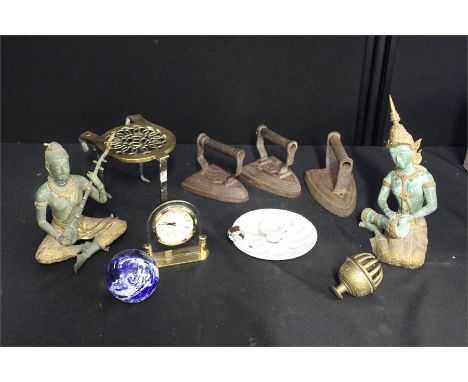 Two metal deity figures, three flat irons, brass trivet, enamel chamber stick etc. (qty)