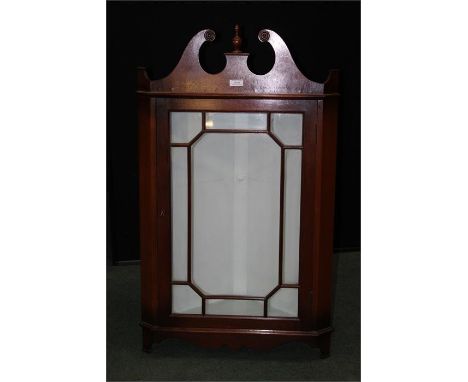 Reproduction mahogany hanging corner cupboard, the broken scroll pediment with urn form finial, astragal glazed door, 54cm wi