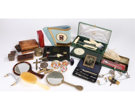 Masonic arm cuff with enamel badge, tortoiseshell effect hand mirror, book form photograph case, three glass paperweights etc