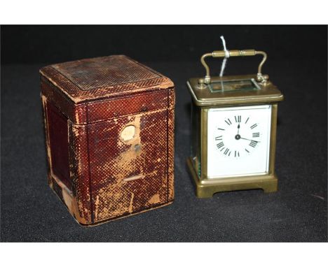 Brass carriage clock, the enamel dial with Roman numerals, the movement stamped France, in a Morocco red leather travelling c