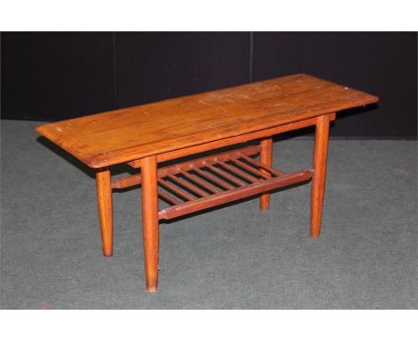 Light oak coffee table, on shaped legs united by a spindle turned undertier, 107cm wide