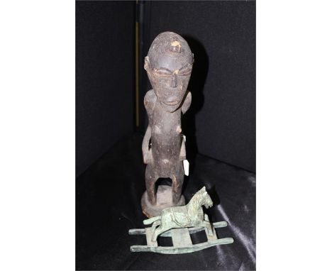 Ethnographical figure, carved as a standing man, together with a rocking horse toy,together with a cane coffee table, with pl