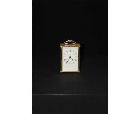 Metamec brass carriage clock, white dial with Roman hour markers, 13 cm in height, together with glassware, including a decan