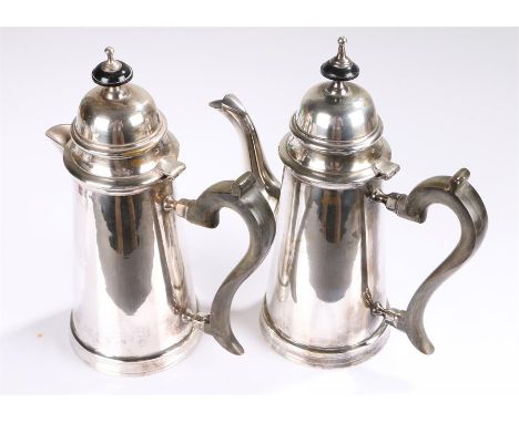 Silver plated coffee pot and hot water jug, with finial tops above hinged lids and arched handles