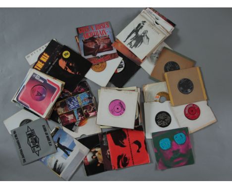 A small vintage box of 7 inch vinyl records (singles) including Bruce Springsteen, The Stranglers, The Moody Blues, Junior Ca