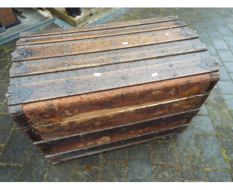 A late 19th/early 20thC domed top trunk with wooden slats, 89cm wide
