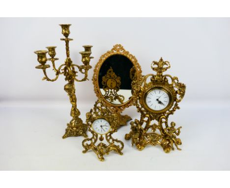 Europa, Jerger - A collection of four brass items including decorative battery powered mantel clocks, candle stand, dressing 