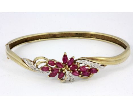 A 9ct yellow gold ruby and diamond set bangle.