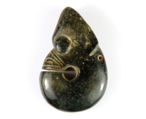 A rare archaic form Chinese dark green jade dragon head amulet, H. 8cm.